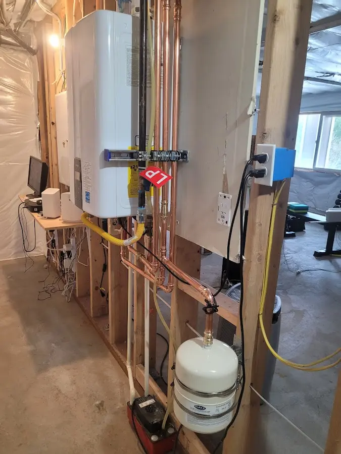 Licensed plumber repairing a kitchen sink in Windham